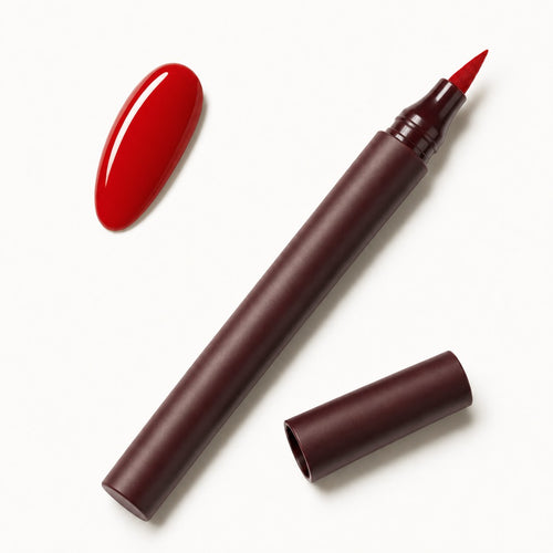 LoveSKN Nail Pen in Classic Red, cap off, next to a glossy red nail swatch